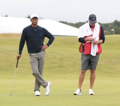 American Tiger Woods stands with his caddy during the second round at the 152nd Open Championship at Royal Troon Golf Club in Troon, Scotland on Friday, July 19, 2024. Tiger Woods missed the cut and finished with a score of fourteen over par.  LON2024071965 HUGOxPHILPOTT