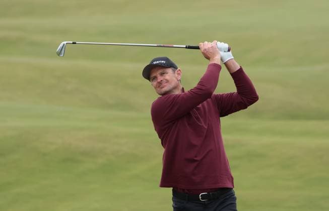 Justin Rose hits an iron on the 13th fairway at the 152nd Open Championship at Royal Troon Golf Club in Troon, Scotland on Sunday, July 21, 2024. Schauffele won by two shots with a score of nine under under par.  LON2024072130A HUGOxPHILPOTT