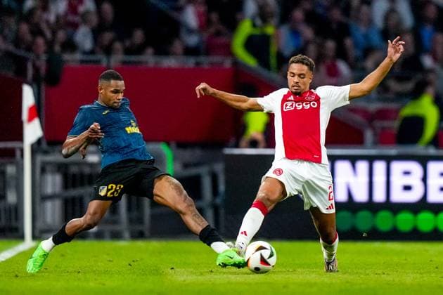 AMSTERDAM , 25-07-2024, JohanCruijff ArenA , Season 2024-2025. UEFA Europa League Second qualifying round Football between Ajax and Vojvodina , Vojvodina player Lucas Barros and Ajax player Devyne Rensch Ajax - Vojvodina  x25835811x Copyright: