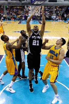 NBA, Basketball Herren, USA 2012: Spurs vs Hornets MAR 24 March 24, 2012: San Antonio Spurs center Tim Duncan 21 rebounds the ball over New Orleans Hornets power forward Gustavo Ayon 15 during the first half of the NBA basketball game between the New Orleans Hornets and the San Antonio Spurs at the New Orleans Arena in New Orleans, LA.(Credit Image: & 169; Jonathan Bachman Cal Media) New Orleans Louisiana U.S. EDITORIAL USE ONLY Copyright: xx ZUMA-20120324_zaf_c04_080.jpg JonathanxBachmanx csmphoto584548