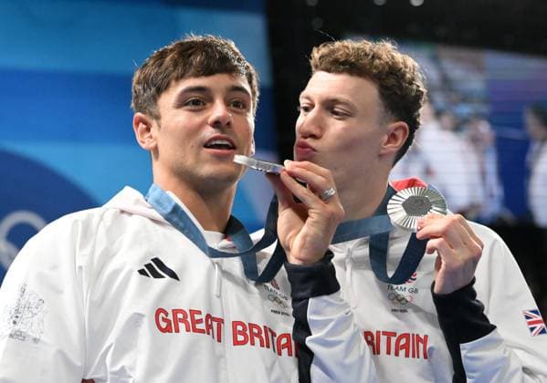 29th July 2024; Paris Olympic Games, Olympische Spiele, Olympia, OS Paris, France, Day 4; Aquatics Centre, Mens Synchronised 10m Platform diving final, Tom Daley and Noah Williams display their silver medals while Noah leans in to Kiss Tom on the cheek  ActionPlus12674107 SimonxWest