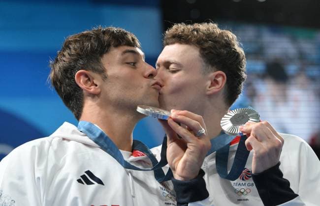 29th July 2024; Paris Olympic Games, Olympische Spiele, Olympia, OS Paris, France, Day 4; Aquatics Centre, Mens Synchronised 10m Platform diving final, Tom Daley and Noah Williams display their silver medals while Noah leans in to Kiss Tom on the cheek  ActionPlus12674108 SimonxWest