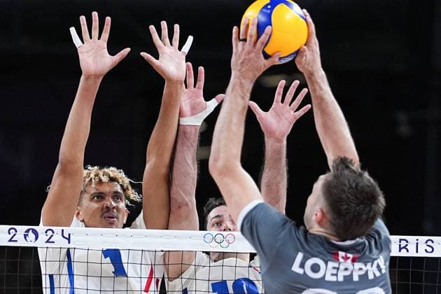 (240730) -- PARIS, July 30, 2024 -- Barthelemy Chinenyeze (1st L) of France blocks an attack by team Canada during the men s volleyball preliminary round pool A match between France and Canada at Paris 2024 Olympic Games, Olympische Spiele, Olympia, OS in Paris, France, July 30, 2024. ) (PARIS2024) FRANCE-PARIS-OLY-VOLLEYBALL JuxHuanzong 