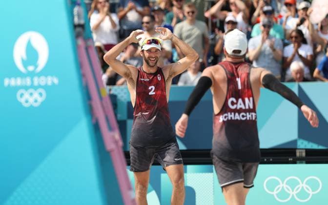 (240802) -- PARIS, Aug. 2, 2024 -- Samuel Schachter (R) Daniel Dearing of Canada celebrate after the men s preliminary phase pool E of Beach volleyball, Beachvolleyball between Julian Hoerl Alexander Horst of Austria and Samuel Schachter Daniel Dearing of Canada at the Paris 2024 Olympic Games, Olympische Spiele, Olympia, OS in Paris, France, Aug. 2, 2024. ) (PARIS2024) FRANCE-PARIS-OLY-BEACH VOLLEYBALL HuangxZongzhi 