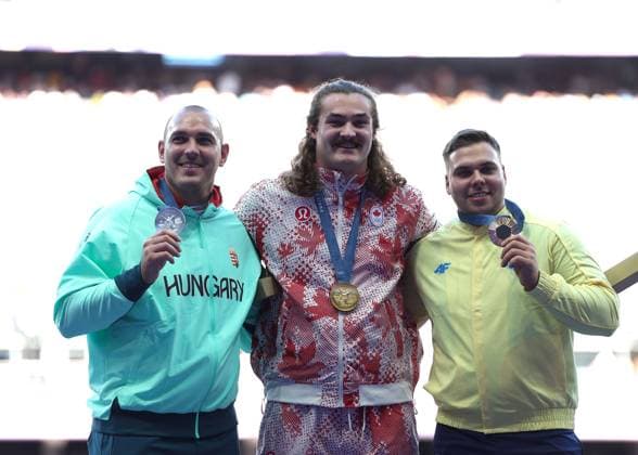 (240805) -- PARIS, Aug. 5, 2024 -- Gold medalist Ethan Katzberg (C) of Canada, silver medalist Bence Halasz (L) of Hungary and bronze medalist Mykhaylo Kokhan of Ukraine react during the victory ceremony of the men s hammer throw of Athletics at the Paris 2024 Olympic Games, Olympische Spiele, Olympia, OS in Paris, France, Aug. 5, 2024. ) (PARIS2024) FRANCE-PARIS-OLY-ATHLETICS-HAMMER THROW-MEN LixYing 