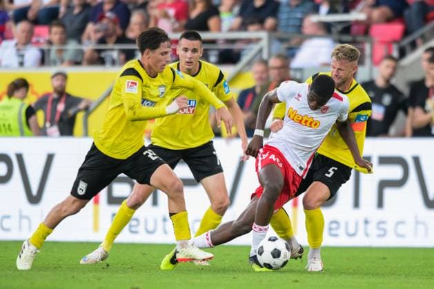 Fußball, 2. Bundesliga, 20240809, SSV Jahn Regensburg - SSV Ulm 1846. Im Bild Max BRANDT (SSV Ulm 1846, 23), Bastian ALLGEIER (SSV Ulm 1846, 7), Mansour OURO-TAGBA (SSV Jahn Regensubrg, 40) Dribbling Ball und Johannes REICHERT (SSV Ulm 1846, 5). Regensburg Jahnstadion Bayern Deutschland