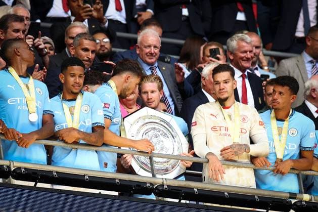 Kevin de Bruyne of Manchester City and Ruben Dias of Manchester City prepare to lift the Community Shield Manchester City v Manchester United, ManU FA Community Shield, Football, Wembley Stadium, London, UK, 10 Aug 2024 EDITORIAL USE ONLY No use with unauthorised audio, video, data, fixture lists, club league logos or live services. Online in-match use limited to 120 images, no video emulation. No use in betting, games or single club league player publications. Copyright: xSimonxDael Shutterstockx 14623051fk