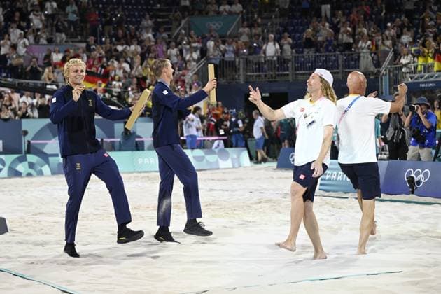 PARIS, FRANKRIKE 20240810 Sveriges David Ahman och Jonatan Hellvig dansar med sina tränare efter att ha vunnit guld i herrarnas final i beachvolleyboll pa Eiffel Tower - Centre Court, under sommar-OS i Paris.