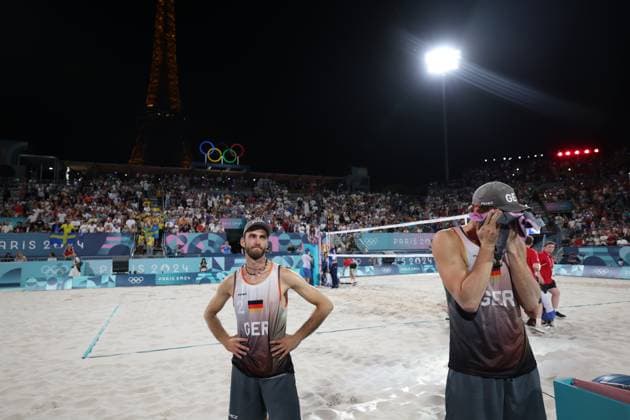 (240810) -- PARIS, Aug. 10, 2024 -- Nils Ehlers (L) Clemens Wickler of Germany react after their defeat in the Beach volleyball, Beachvolleyball men s gold medal match between Nils Ehlers Clemens Wickler of Germany and David Ahman Jonatan Hellvig of Sweden at the Paris 2024 Olympic Games, Olympische Spiele, Olympia, OS in Paris, France, Aug. 10, 2024. ) (PARIS2024) FRANCE-PARIS-OLY-BEACH VOLLEYBALL HuangxZongzhi 