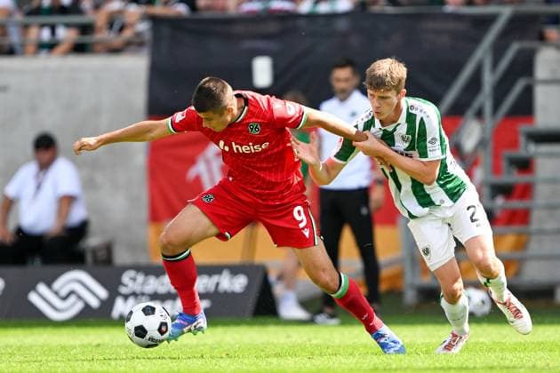 2. Bundesliga - SC Preußen Münster - Hannover 96 am 11.08.2024 im Preußenstadion in Münster Nicolo Tresoldi (Hannover 96) im Zweikampf gegen Jano ter Horst (Muenster).