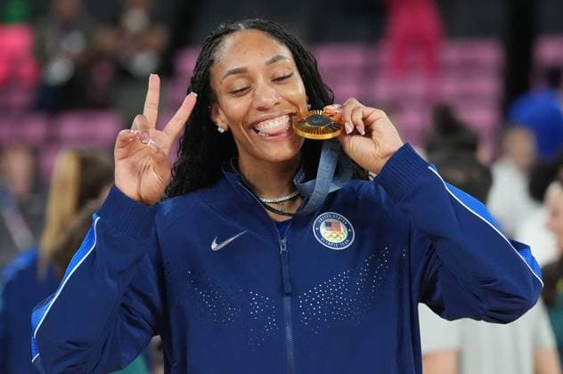A Ja Wilson of the U.S. bites her gold medal at the awards ceremony for Women s Basketball at the Paris 2024 Olympic Games, Olympische Spiele, Olympia, OS at the Bercy Arena in Paris, France, on Sunday, August 11, 2024. The U.S. defeated France 67-66 in the gold medal game.  OLY202408111773 RICHARDxELLIS