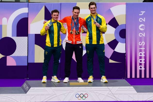 PARIS, FRANCE - AUGUST 11: Harrie Lavreysen of Team Netherlands celebrates winning Gold on the Podium with Matthew Glaetzer of Team Australia and Matthew Richardson of Team Australia in the Men™s Keirin Final during the Cycling Track Paris 2024 Olympic Games, Olympische Spiele, Olympia, OS at the National Veladrome on August 11, 2024 in Paris, France. (Photo by Pete Dovgan Speed Media Icon Sportswire) OLYMPICS: AUG 11 Paris 2024 EDITORIAL USE ONLY Icon2408110209