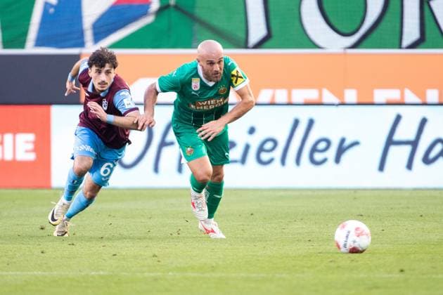 SOCCER - UEFA CL, Rapid vs Trabzonspor VIENNA,AUSTRIA,15.AUG.24 - SOCCER - UEFA Champions League, qualification, SK Rapid Wien vs Trabzonspor Kuluebue. Image shows Cihan Canak (Trabzonspor) and Lukas Grgic (Rapid).  GEPAxpictures xPhilippxBrem