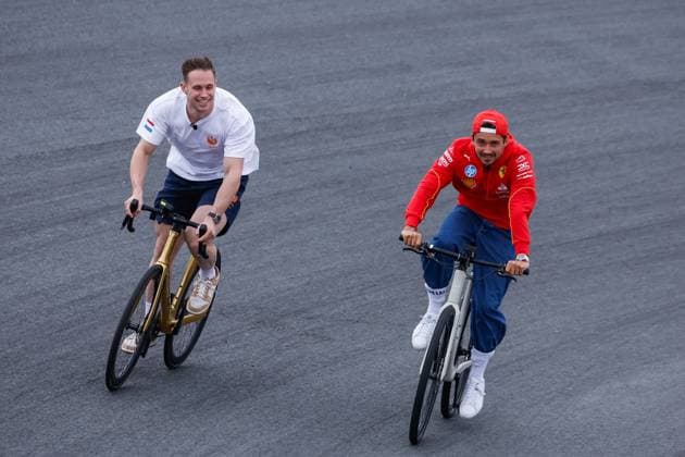 Harry Lavreysen dutch olympic champion track cyclist on his golden bike shows his three golden medals and Charles Leclerc of Monaco and Scuderia Ferrari during previews ahead of the F1 Grand Prix of Netherlands at Circuit Park Zandvoort on August 22, 2024 in Zandvoort, Netherlands. Defodi-704_MTB20240822F1ZandvoortDag1352540