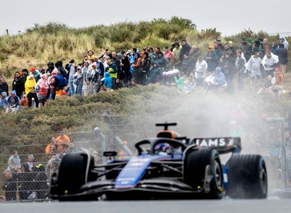 ZANDVOORT - Audience in the rain watches Alexander Albon (Williams) in action during the 1st free practice in the run-up to the F1 Grand Prix of the Netherlands at the Circuit of Zandvoort. ANP REMKO DE WAAL xVIxANPxSportx xxANPxIVx 506554839 originalFilename: 506554839.jpg