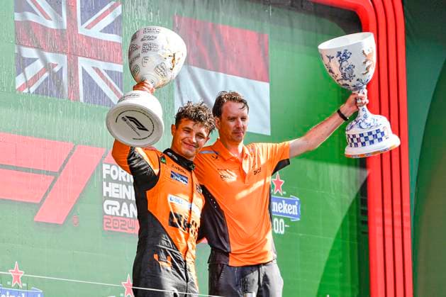 25th August 2024; Circuit Zandvoort, Zandvoort, North Holland, Netherlands; Formula 1 Heineken Dutch Grand Prix 2024; Race Day; Lando Norris lifts the winners trophy as Will Joseph, Director, Race Engineering at McLaren accepts the constructors trophy  ActionPlus12686047 GodfreyxPitt