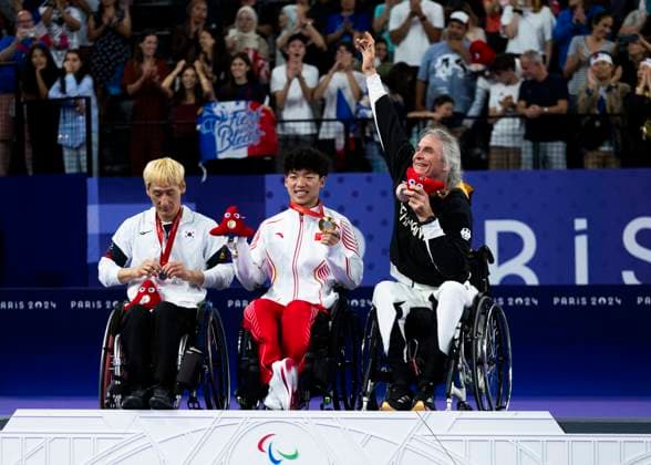 PARIS, FRANCE - SEPTEMBER 02: Thomas WANDSCHNEIDER (GER), startclass WH1 wins the bronce medal and celebrates during the winning ceremony Paris 2024 Summer Paralympic Games at Porte de la Chapelle Arena on September 02, 2024 in Paris, France. (Photo by Mika Volkmann DBS)