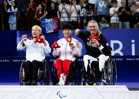 PARIS, FRANCE - SEPTEMBER 02: Thomas WANDSCHNEIDER (GER), startclass WH1 wins the bronce medal and celebrates during the winning ceremony Paris 2024 Summer Paralympic Games at Porte de la Chapelle Arena on September 02, 2024 in Paris, France. (Photo by Mika Volkmann DBS)