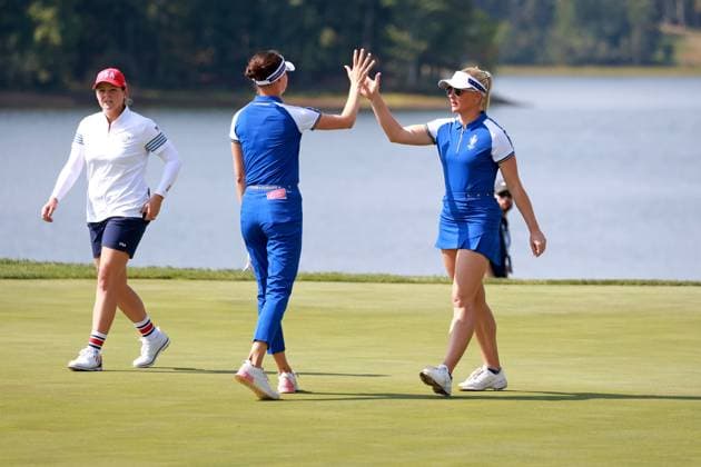 GAINESVILLE, VA - SEPTEMBER 14: Team Europe golfers Esther Henseleit and Charley Hull high five each other after winning their match on the 18th hole during Saturday Foursomes during the 2024 Solheim Cup on September 14, 2024 at Robert Trent Jones Golf Club at Gainesville, Virginia. (Photo by Brian Spurlock Icon Sportswire) GOLF: SEP 14 Solheim Cup EDITORIAL USE ONLY Icon24091449