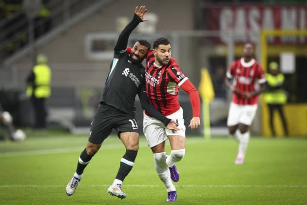 Theo Hernandez of Milan grapples with Mohamed Salah of Liverpool AC Milan v Liverpool, UEFA Champions League, Group Stage, Football, San Siro, Milan, Italy, 17 Sep 2024 EDITORIAL USE ONLY No use with unauthorised audio, video, data, fixture lists, club league logos or live services. Online in-match use limited to 120 images, no video emulation. No use in betting, games or single club league player publications.  Copyright: xSimonxDael Shutterstockx 14722111bm