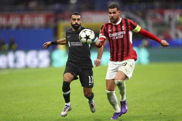 Mohamed Salah of Liverpool and Theo Hernandez of Milan battle for the ball AC Milan v Liverpool, UEFA Champions League, Group Stage, Football, San Siro, Milan, Italy, 17 Sep 2024 EDITORIAL USE ONLY No use with unauthorised audio, video, data, fixture lists, club league logos or live services. Online in-match use limited to 120 images, no video emulation. No use in betting, games or single club league player publications.  Copyright: xSimonxDael Shutterstockx 14722111ef