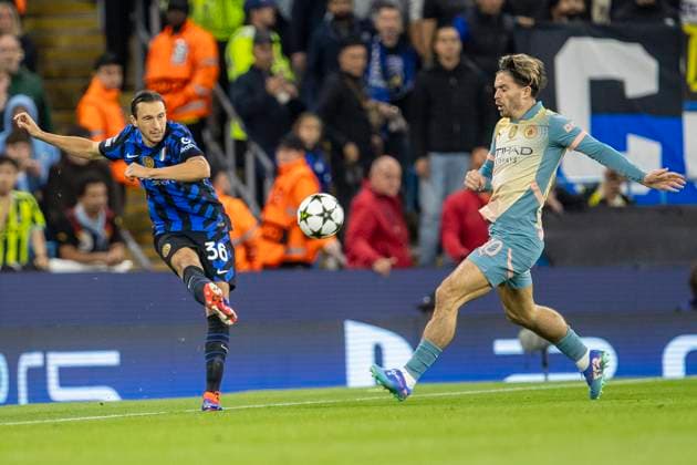 18th September 2024; Etihad Stadium, Manchester, England; UEFA Champions League Football, Manchester City versus Inter Milan; Matteo Darmian of Inter Milan crosses the ball in frobt of Jack Grealish of Manchester City  ActionPlus12694285 TimxWilliams