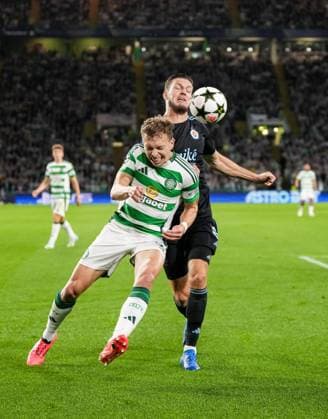 Alistair Johnston of Celtic challenges for the ball with Kevin Wimmer of Slovan Bratislava. Celtic v Slovan Bratislava, UEFA Champions League, Group Stage, Football, Celtic Park, Glasgow, Scotland, UK, 18 Sep 2024 EDITORIAL USE ONLY No use with unauthorised audio, video, data, fixture lists, club league logos or live services. Online in-match use limited to 120 images, no video emulation. No use in betting, games or single club league player publications. Copyright: xStuartxWallace Shutterstockx 14722221q
