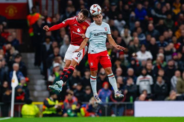 Bruno Fernandes of Manchester United, ManU Bart van Rooij of FC Twente heads the ball , UEFA Europa League 2024 25 League Phase MD1, Manchester United v FC Twente, Old Trafford, September 25, 2024, Manchester, England.