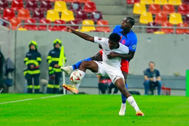 (240927) -- BUCHAREST, Sept. 27, 2024 -- FK RFS s Rostand Ndjiki (front) vies with FCSB s Joyskim Dawa during a UEFA Europa League match between FCSB and FK RFS in Bucharest, Romania, Sept. 26, 2024. (Photo by Xinhua) (SP)ROMANIA-BUCHAREST-UEFA EUROPA LEAGUE-FCSB VS FK RFS CristianxCristel 