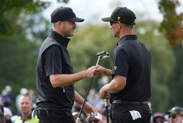 September 27, 2024, Montreal, Pq, CANADA: International team member Taylor Pendrith of Canada, left fist bumps Adam Scott of Australia, on the first hole during their second round foursome match at the Presidents Cup golf tournament at the Royal Montreal Golf Club, in Montreal, Friday, Sept. 27, 2024. Canada News - September 27, 2024 - ZUMAc35_ 20240927_zaf_c35_105 Copyright: xChristinnexMuschix