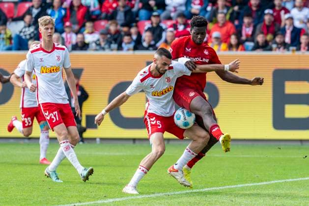 28.09.2024: Fußball, 2. Bundesliga: SSV Jahn Regensburg - 1. FC Kaiserslautern, Saison 2024 2025 im Jahnstadion. Regensburgs Rasim Bulic (l) und Lautern Ragnar Ache kämpfen um den Ball. WICHTIGER HINWEIS: Gemäß den Vorgaben der DFL Deutsche Fußball Liga bzw. des DFB Deutscher Fußball-Bund ist es untersagt, in dem Stadion und oder vom Spiel angefertigte Fotoaufnahmen in Form von Sequenzbildern und oder videoähnlichen Fotostrecken zu verwerten bzw. verwerten zu lassen.