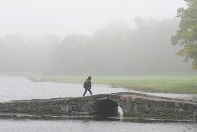 September 28, 2024, Montreal, Pq, Canada: A fan crosses the bridge on the 16th hole during a fog delay during third round four-ball play at the Presidents Cup golf tournament at Royal Montreal Golf Club, in Montreal, Saturday, Sept. 28, 2024. Canada News - September 28, 2024  - ZUMAc35_ 20240928_zaf_c35_004 Copyright: xNathanxDenettex