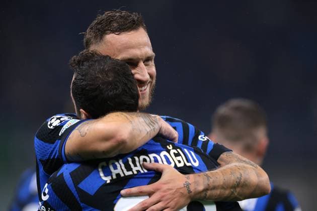 Milan, Italy, 1st October 2024. Hakan Calhanoglu of FC Internazionale celebrates with team mate Marko Arnautovic after scoring to give the side a 1-0 lead during the UEFA Champions League match at Giuseppe Meazza, Milan. Picture credit should read: Jonathan Moscrop Sportimage EDITORIAL USE ONLY. No use with unauthorised audio, video, data, fixture lists, club league logos or live services. Online in-match use limited to 120 images, no video emulation. No use in betting, games or single club league player publications. SPI-3339-0014
