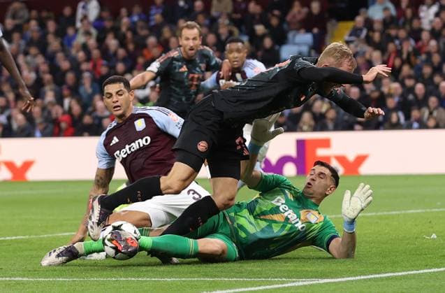 Birmingham, England, 2nd October 2024. Konrad Laimer of Bayern Munich is challenged by Emiliano Martinez and Diego Carlos of Aston Villa during the UEFA Champions League match at Villa Park, Birmingham. Picture credit should read: Cameron Smith Sportimage EDITORIAL USE ONLY. No use with unauthorised audio, video, data, fixture lists, club league logos or live services. Online in-match use limited to 120 images, no video emulation. No use in betting, games or single club league player publications. SPI-3354-0058