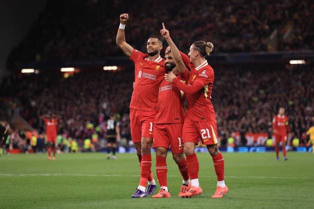 Liverpool v Bologna UEFA Champions League 2nd October 2024 - UEFA Champions League - Liverpool FC v Bologna FC - Cody Gakpo and Mohamed Salah of Liverpool celebrates the second goal with Kostas Tsimikas - Photo: Simon Stacpoole Offside. Liverpool UK Copyright: xSimonxStacpoolexOffside