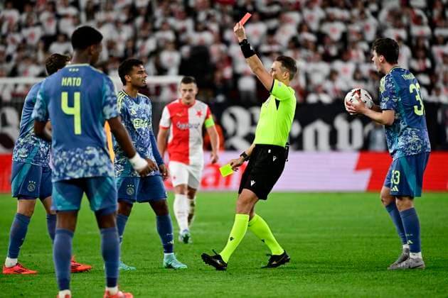 Referee Andris Treimanis awards a red card to Youri Baas (not seen) during the Football Europa League 2nd round match SK Slavia Prague vs Ajax Amsterdam in Prague, Czech Republic, October 3, 2024. (CTKxPhoto OndrejxDeml) CTKPhotoP2024100307575  CTKPhotoP2024100307575