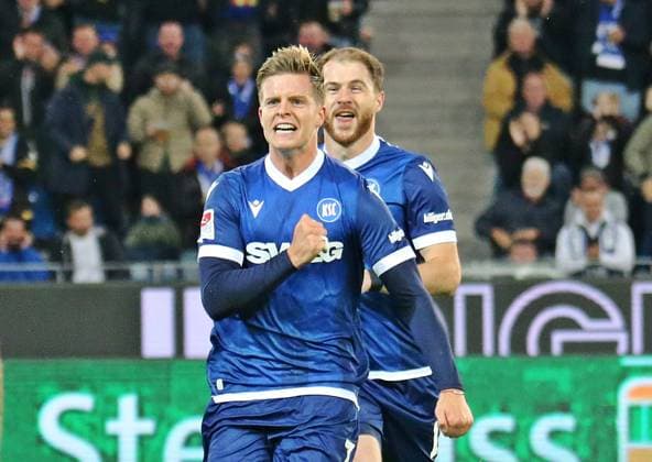 04.10.2024, xmohx, Fussball 2.Bundesliga, Karlsruher SC - SV Darmstadt 98 emspor, v.l. Budu Zivzivadze und Dzenis Burnic (karslruhe) bejubeln das 1-0 (DFL DFB REGULATIONS PROHIBIT ANY USE OF PHOTOGRAPHS as IMAGE SEQUENCES and or QUASI-VIDEO) Karlsruhe