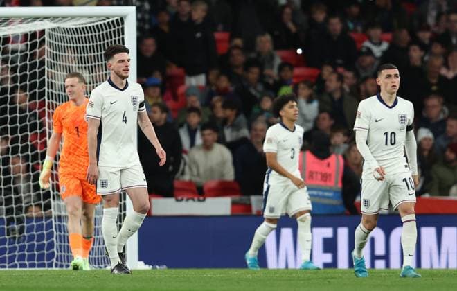 London, England, 10th October 2024. Declan Rice and Phil Foden of England look Vangelis Pavlidis (not pictured) of Greece celebrates after scoring the opening goal during the UEFA Nations League match at Wembley Stadium, London. Picture credit should read: Paul Terry Sportimage EDITORIAL USE ONLY. No use with unauthorised audio, video, data, fixture lists, club league logos or live services. Online in-match use limited to 120 images, no video emulation. No use in betting, games or single club league player publications. SPI-3369-0020
