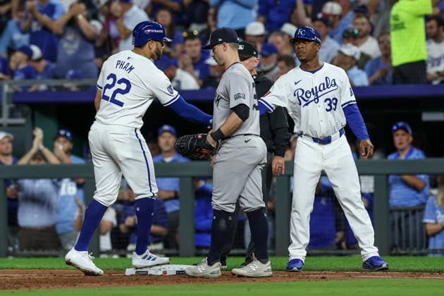 October 10, 2024: Kansas City Royals right fielder Tommy Pham (22) is congratulated on his single by Kansas City Royals first base coach Damon Hollins (39) as New York Yankees first baseman Jon Berti (19) looks on during the third inning of game 4 of the American League Division Series at Kauffman Stadium in Kansas City, MO. CSM Kansas City United States of America - ZUMAc04_ 20241010_zma_c04_066 Copyright: xDavidxSmithx