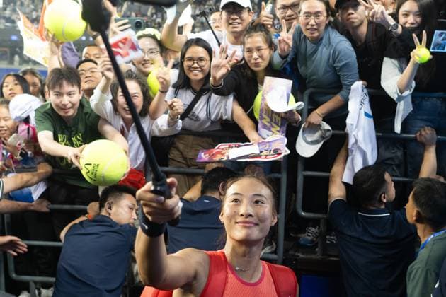 (241011) -- WUHAN, Oct. 11, 2024 -- Zheng Qinwen (Front) takes selfie with fans after the women s singles quarterfinal match between Zheng Qinwen of China and Jasmine Paolini of Italy at the 2024 Wuhan Open tennis tournament in Wuhan, capital of central China s Hubei Province, Oct. 11, 2024. ) (SP)CHINA-WUHAN-TENNIS-WUHAN OPEN-WOMEN S SINGLES (CN) XiaoxYijiu 