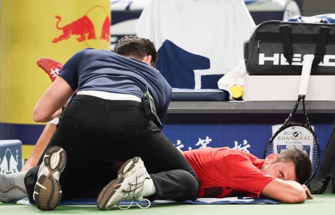 (241012) -- SHANGHAI, Oct. 12, 2024 -- Novak Djokovic receives medical timeout during the men s singles semifinal match between Taylor Fritz of the United States and Novak Djokovic of Serbia at the ATP, Tennis Herren World Tour Shanghai Masters tennis tournament in Shanghai, east China, Oct. 12, 2024. ) (SP)CHINA-SHANGHAI-TENNIS-ATP TOUR-SHANGHAI MASTERS(CN) WangxXiang 