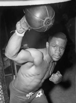 Orig. caption... MOSES GETS UNDER WEIGH MOSES WARD, 23-year-old colored American, was soon in training after his recent arrival. He is seen at work in Toby s gym, Bermondsey, in readiness for his return fight with Yolande Pompee, of Trinidad, at Harringay next Tuesday. Pompee was originally booked for the big match against Archie Moore. Note Gloves Boxing balls Necklace CD491 persons: MOSES WARD sites: GREAT BRITAIN;LONDON;USA * sp_sw x5600x *** Orig caption MOSES GETS UNDER WEIGH MOSES WARD, 23 year old colored American, was soon in training after his recent arrival He is seen at work in Toby s gym, Bermondsey, in readiness for his return fight with Yolande Pompee, of Trinidad, at Harringay next Tuesday Pompee was originally booked for the big match against Archie Moore Note Gloves Boxing balls Necklace CD491 persons MOSES WARD sites GREAT BRITAIN LONDON USA sp sw x5600x  Copyright: xx TRAINING BEFORE THE MATCH