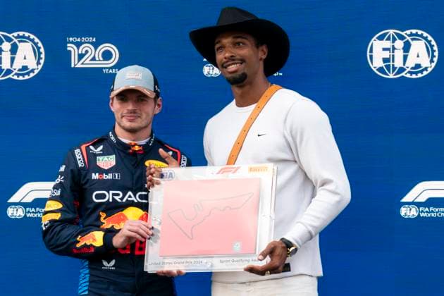Dutch Formula One driver Max Verstappen of Red Bull Racing holds his pole award for sprint qualifying with German track and field athlete Leo Neugebauer during for the Formula One United States Grand Prix at the Circuit of the Americas in Austin, Texas on Friday, October 18, 2024.  AUS2024101865 GREGxNASH