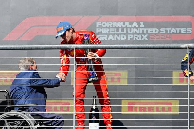 AUSTIN, TX - OCTOBER 20: Texas Governor Greg Abbott shakes hands with Scuderia Ferrari driver Charles Leclerc (16) of Monaco after presenting him with the trophy for winning the Formula 1 Pirelli United States Grand Prix on October 20, 2024, at Circuit of The Americas in Austin, Texas. (Photo by Ken Murray Icon Sportswire) AUTO: OCT 20 F1 Pirelli United States Grand Prix EDITORIAL USE ONLY Icon241020013
