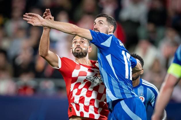 Kenan Bajric (Slovan Bratislava) and Cristian Stuani (Girona FC) battle for the ball during a UEFA Champions League match between Girona FC and Slovan Bratislava at Estadi Municipal de Montilivi in Girona, Girona, Spain, on October 22 2024. Photo by Felipe Mondino Copyright: x@FELIPExMONDINOx