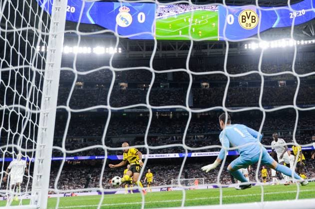 (241023) -- MADRID, Oct. 23, 2024 -- Donyell Malen (front L) of Borussia Dortmund shoots to score during the third round match of UEFA Champions League between Real Madrid and Borussia Dortmund in Santiago Bernabeu stadium, Madrid, Spain, Oct. 22, 2024. (Photo by Xinhua) (SP)SPAIN-MADRID-FOOTBALL-UEFA CHAMPIONS LEAGUE-REAL MADRID VS DORTMUND GustavoxValiente 