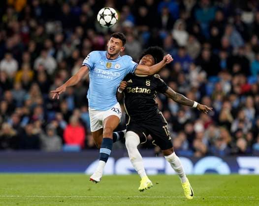 Manchester, England, 23rd October 2024. Matheus Nunes of Manchester City with Angelo Preciado of Sparta Prague during the UEFA Champions League match at the Etihad Stadium, Manchester. Picture credit should read: Andrew Yates Sportimage EDITORIAL USE ONLY. No use with unauthorised audio, video, data, fixture lists, club league logos or live services. Online in-match use limited to 120 images, no video emulation. No use in betting, games or single club league player publications. SPI-3405-0024