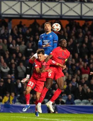 Rangers captain James Tavernier challenges for the ball with Risto Radunovic & Joyskim Dawa of FCSB. Rangers v FCSB, UEFA Europa League, Group Stage, Football, Ibrox Stadium, Glasgow, Scotland, UK, 24 Oct 2024 EDITORIAL USE ONLY No use with unauthorised audio, video, data, fixture lists, club league logos or live services. Online in-match use limited to 120 images, no video emulation. No use in betting, games or single club league player publications. Copyright: xStuartxWallace Shutterstockx 14801669el