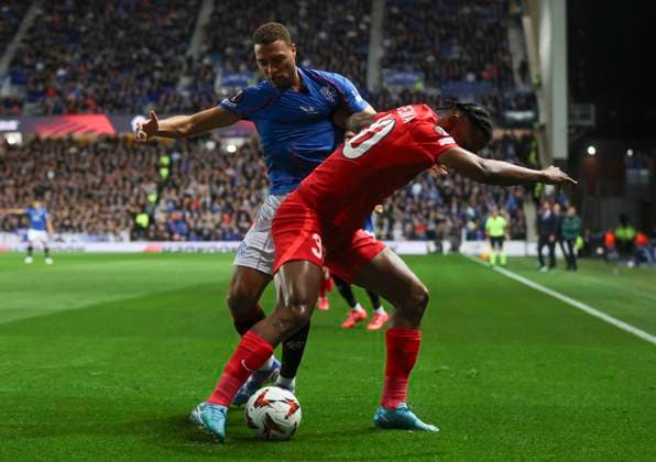 Football - 2024 2025 UEFA Europa League - League Phase - Matchday Three of Eight - Glasgow Rangers vs FCSB - Ibrox Stadium - Thursday 23rd October 2024 Siyabonga Ngezana of FCSB vies with Cyriel Dessers of Rangers 