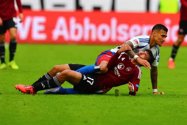 GER, Hamburg, Fussball, DFB, HSV vs 1. FC Nuernberg, im Volkspark Stadion, 03.11.2024, v.l. Jens Castrop (1. FC Nuernberg) , Davie Selke (Hamburger SV) liegen auf den Boden nach dem Faul DFL regulations prohibit any use of photographs as image sequences and or quasi-video.